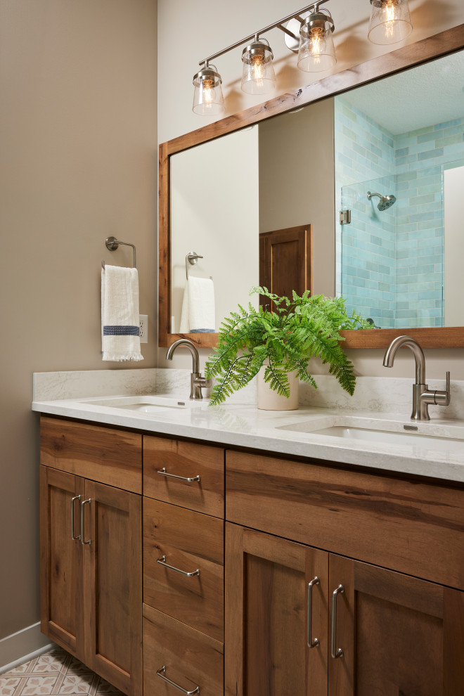 Alcove shower - mid-sized transitional master multicolored tile and ceramic tile ceramic tile, beige floor and double-sink alcove shower idea in Minneapolis with shaker cabinets, medium tone wood cabinets, a one-piece toilet, beige walls, an undermount sink, quartz countertops, a hinged shower door, beige countertops, a niche and a built-in vanity