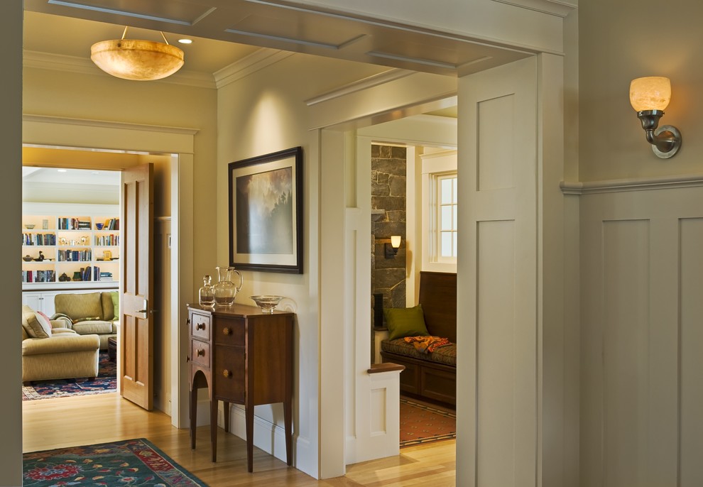 This is an example of a traditional entryway in Burlington with beige walls and light hardwood floors.