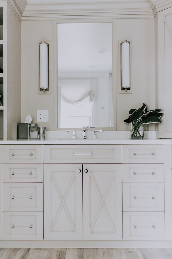 Design ideas for a large transitional master bathroom in Cleveland with beaded inset cabinets, white cabinets, a corner shower, a two-piece toilet, white tile, marble, grey walls, dark hardwood floors, an undermount sink, quartzite benchtops, brown floor and a hinged shower door.