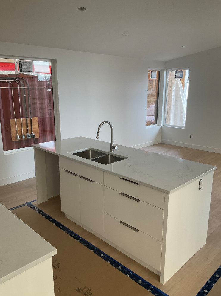 Bathroom with floating wooden vanity, double sinks, and round mirrors on white t