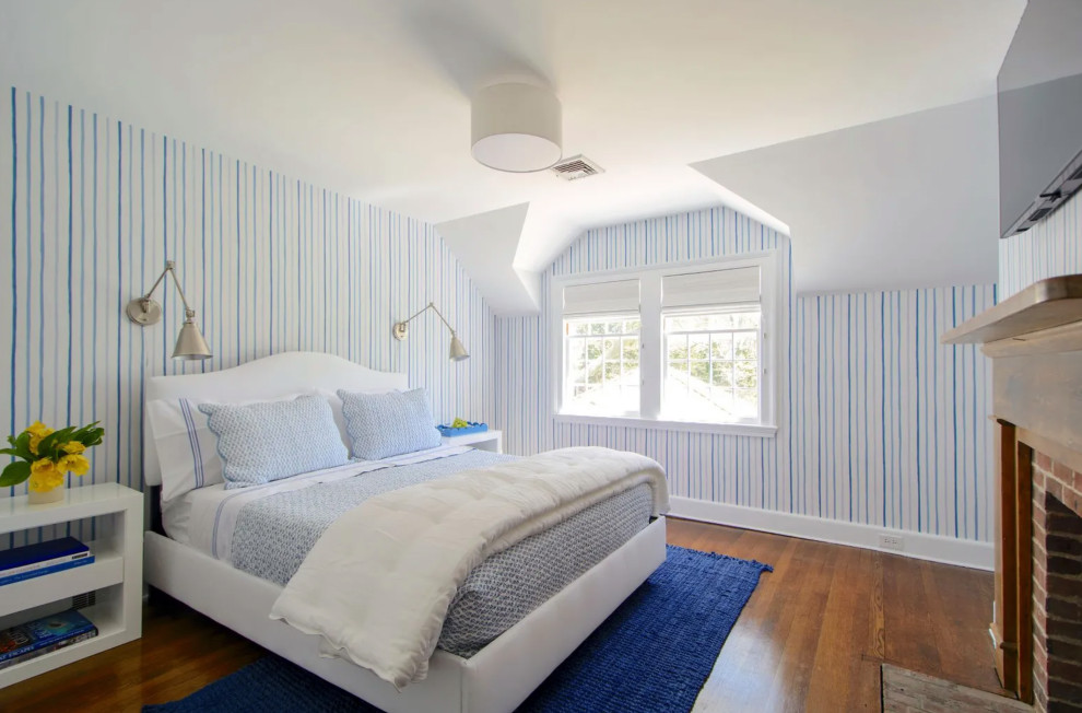 Inspiration for a mid-sized coastal guest medium tone wood floor, brown floor, tray ceiling and wallpaper bedroom remodel in New York with blue walls