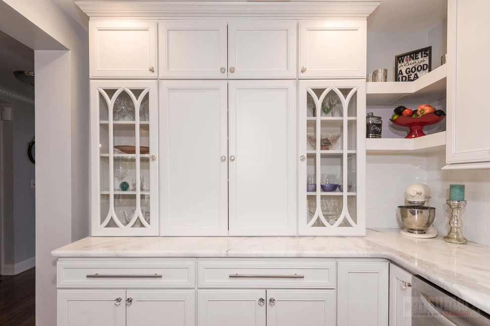 Photo of a large u-shaped eat-in kitchen in New York with an undermount sink, flat-panel cabinets, white cabinets, quartzite benchtops, white splashback, porcelain splashback, stainless steel appliances, plywood floors and with island.