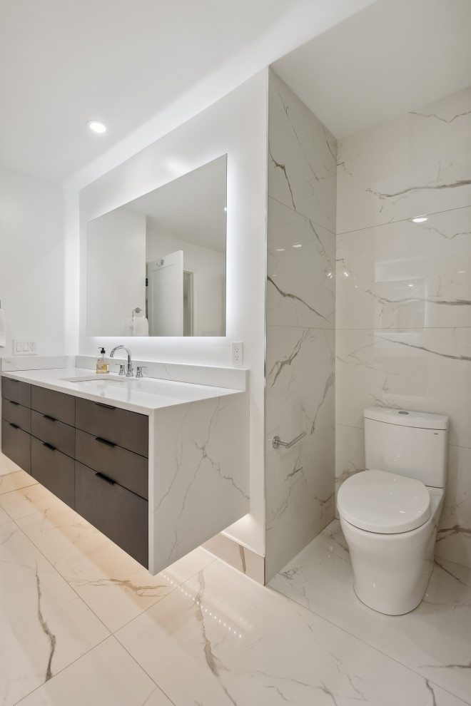 Inspiration for a medium sized traditional ensuite bathroom in DC Metro with flat-panel cabinets, brown cabinets, a freestanding bath, a corner shower, a bidet, beige tiles, ceramic tiles, grey walls, ceramic flooring, a submerged sink, engineered stone worktops, grey floors, a hinged door, white worktops, a shower bench, double sinks and a floating vanity unit.