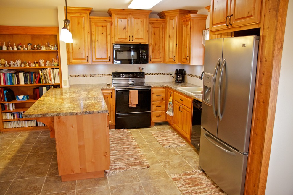 Open concept kitchen - small u-shaped open concept kitchen idea with a drop-in sink, raised-panel cabinets, light wood cabinets, laminate countertops, white backsplash, stainless steel appliances and a peninsula