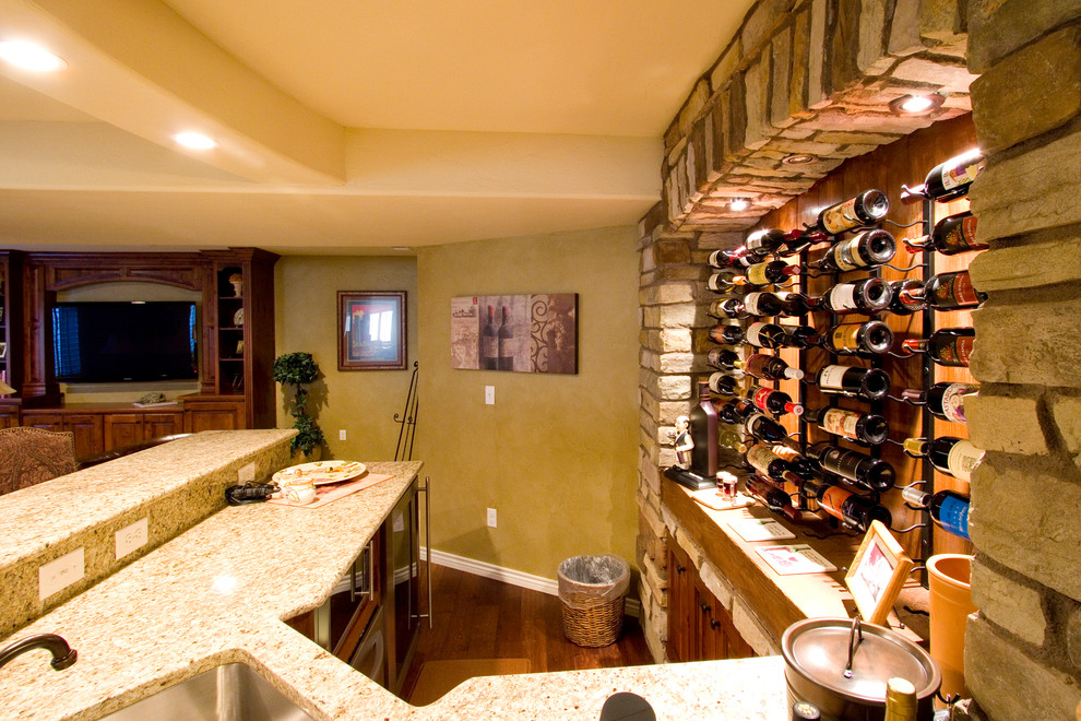 This is an example of a large country wine cellar in Denver with storage racks and carpet.
