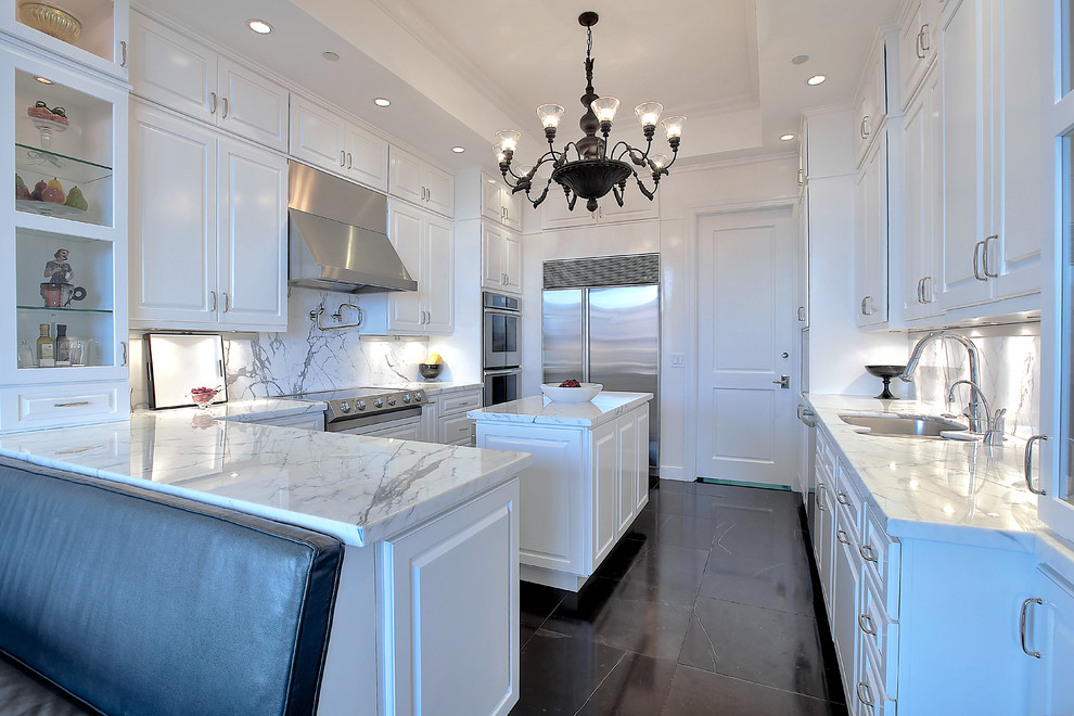 Photo of a transitional u-shaped eat-in kitchen in New York with a double-bowl sink, raised-panel cabinets, white cabinets, white splashback, stainless steel appliances and black floor.