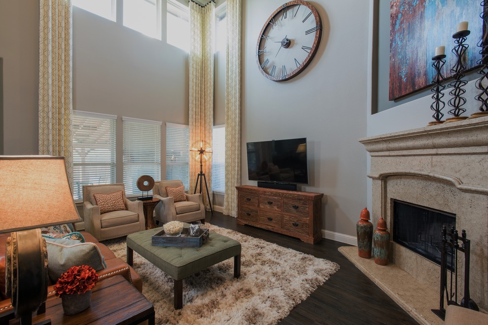 Design ideas for a large country open concept family room in Dallas with grey walls, dark hardwood floors, a corner fireplace, a stone fireplace surround, a wall-mounted tv and brown floor.