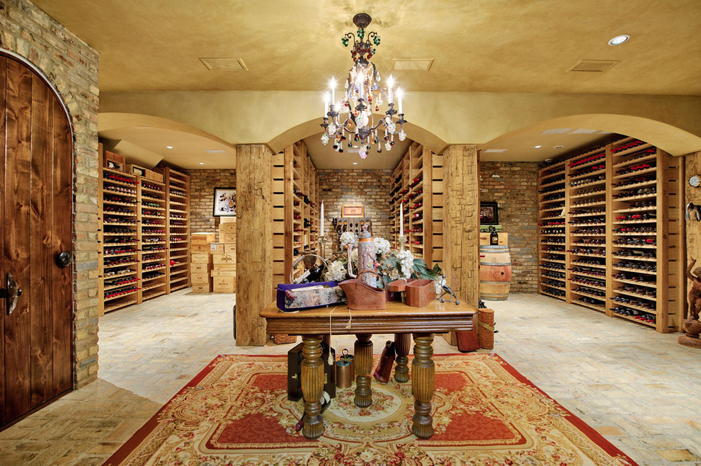 Expansive traditional wine cellar in Chicago with storage racks and brick floors.