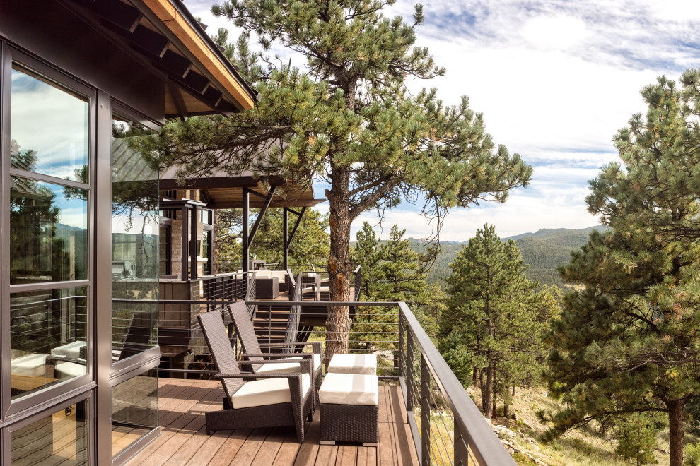 Mountain style backyard second story cable railing deck photo in Denver