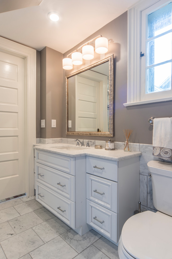 Example of a small transitional 3/4 gray tile and porcelain tile porcelain tile and gray floor bathroom design in Denver with furniture-like cabinets, white cabinets, a one-piece toilet, brown walls, an undermount sink and quartzite countertops