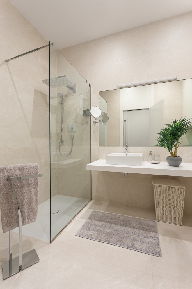 Photo of a transitional master bathroom in Barcelona with beige cabinets, a drop-in tub, a curbless shower, a two-piece toilet, beige tile, porcelain tile, beige walls, porcelain floors, a vessel sink, engineered quartz benchtops, beige floor, a hinged shower door, white benchtops, an enclosed toilet, a single vanity and a built-in vanity.