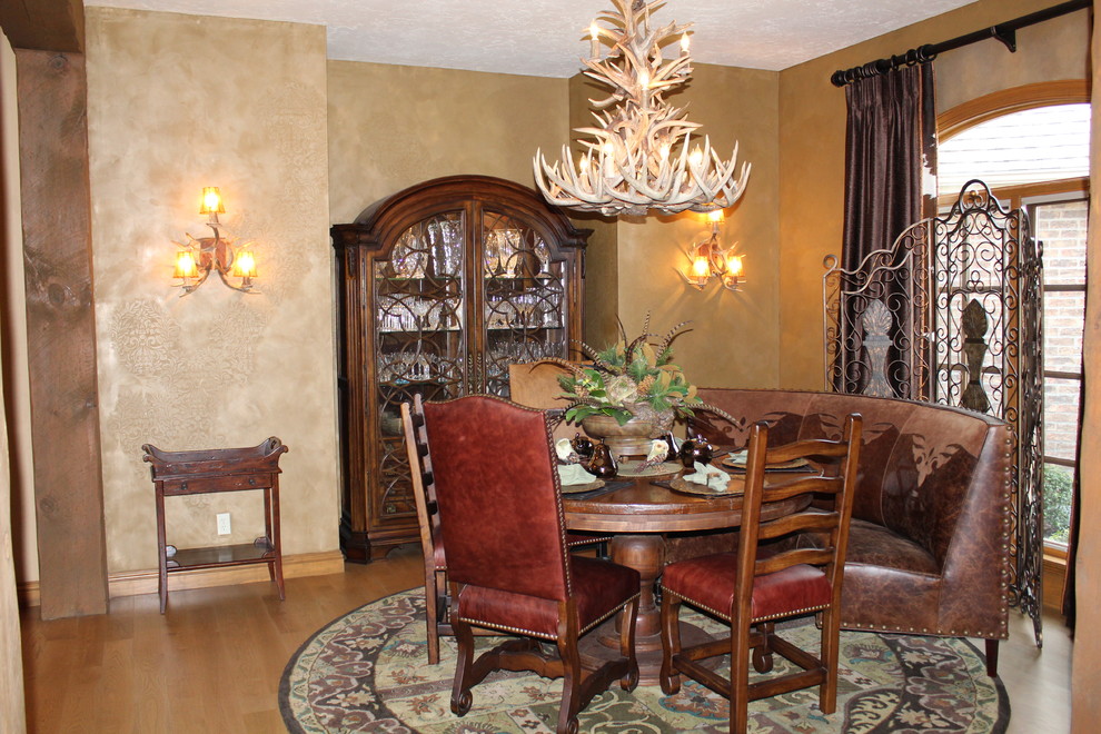 Example of a mid-sized mountain style light wood floor and brown floor enclosed dining room design with brown walls and no fireplace