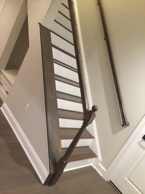 Example of a mid-sized transitional underground dark wood floor and brown floor basement design with beige walls and no fireplace