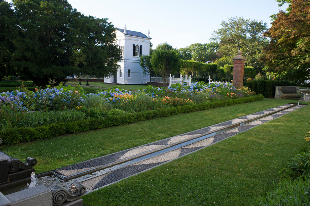 Photo of a traditional garden in Providence with a water feature.