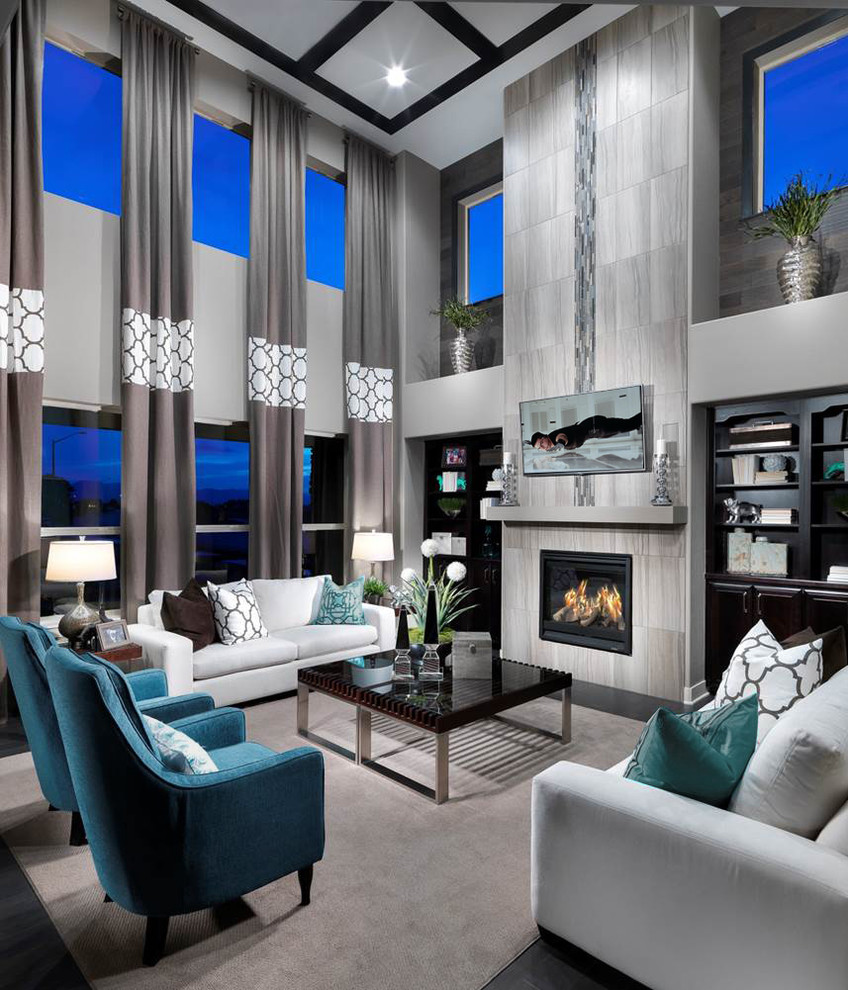Photo of a large contemporary open concept family room in Denver with grey walls, a standard fireplace, a tile fireplace surround and a wall-mounted tv.