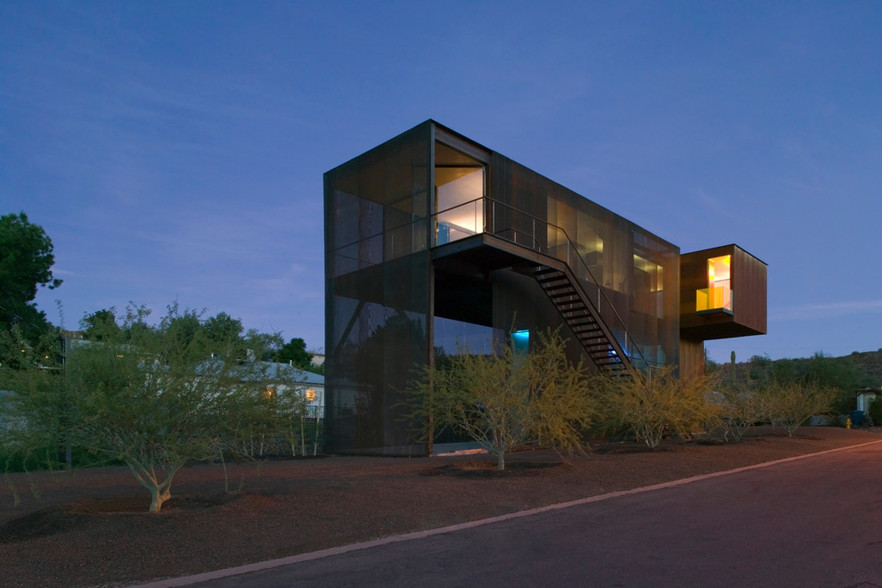 Design ideas for a contemporary two-storey exterior in Phoenix with metal siding.