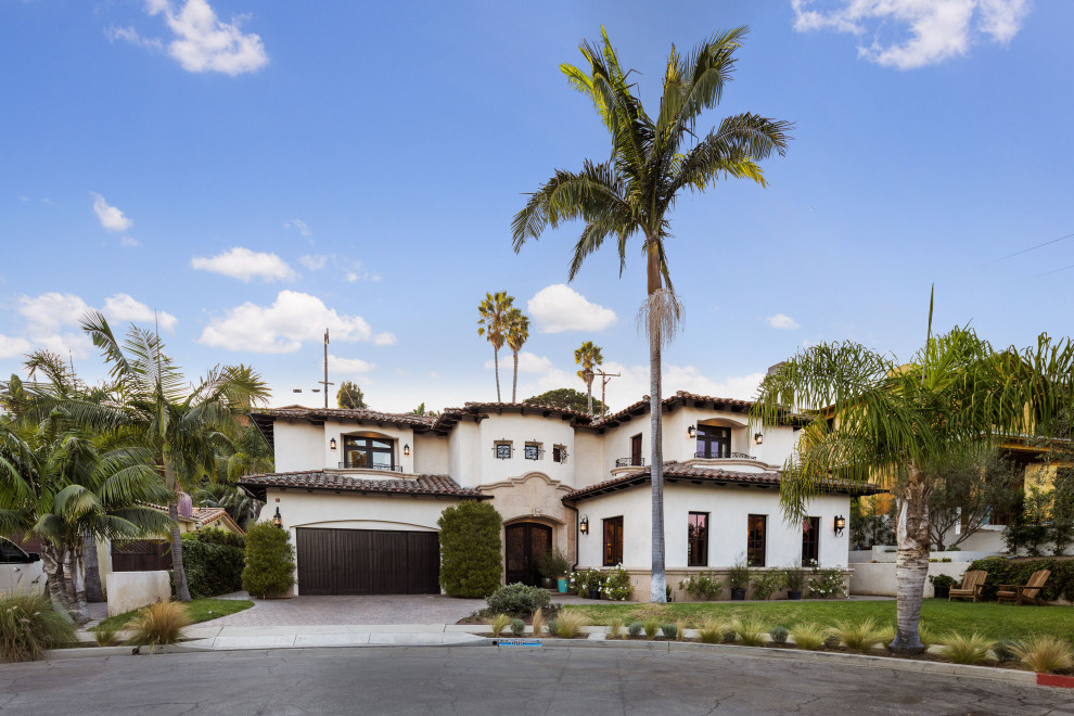 This is an example of a large beach style two-storey beige house exterior in Los Angeles.