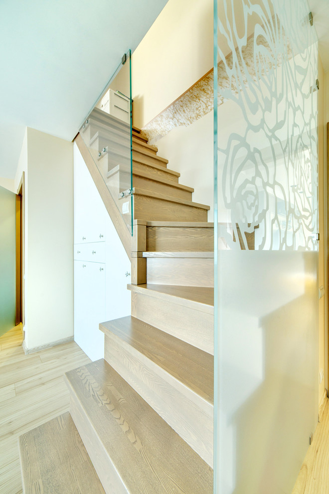 Design ideas for a wood l-shaped staircase in Other with wood risers and glass railing.