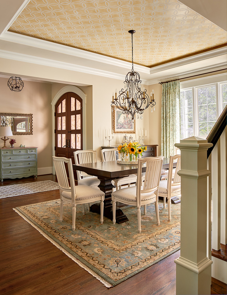 This is an example of a traditional dining room in Charlotte with beige walls and medium hardwood floors.