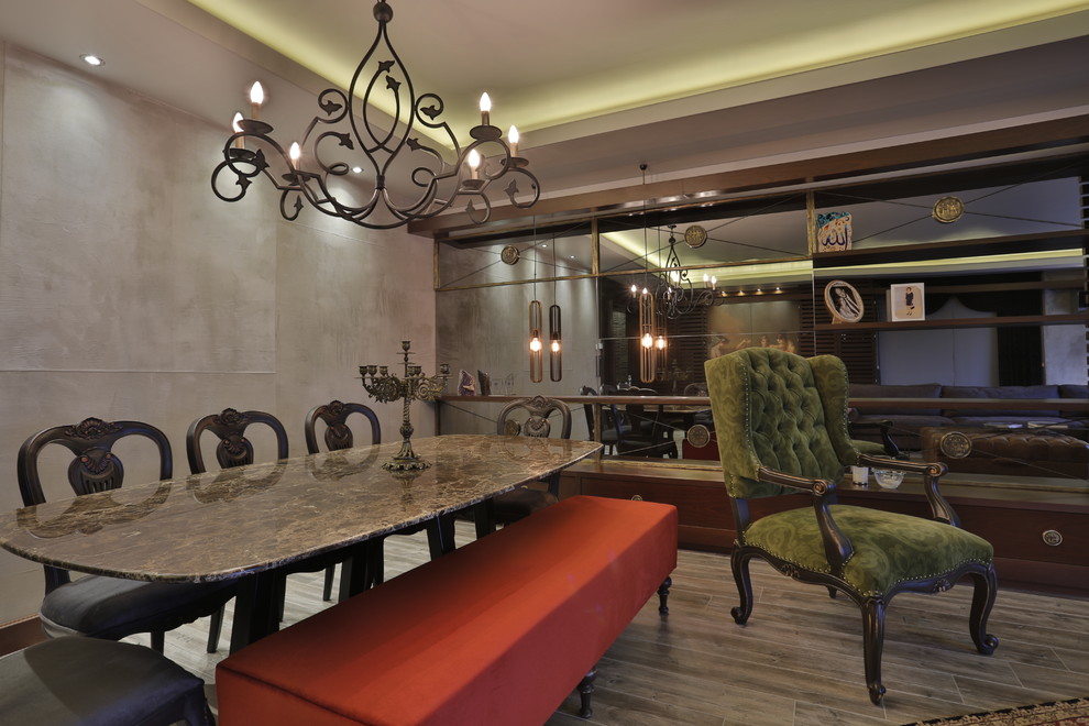 Mid-sized transitional open concept medium tone wood floor dining room photo with gray walls and a media wall