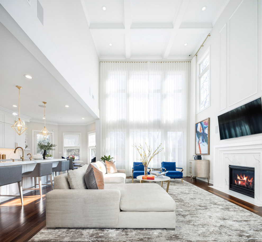Design ideas for an expansive traditional open concept family room in New York with white walls, medium hardwood floors, a standard fireplace, a stone fireplace surround, a wall-mounted tv, brown floor, coffered and decorative wall panelling.
