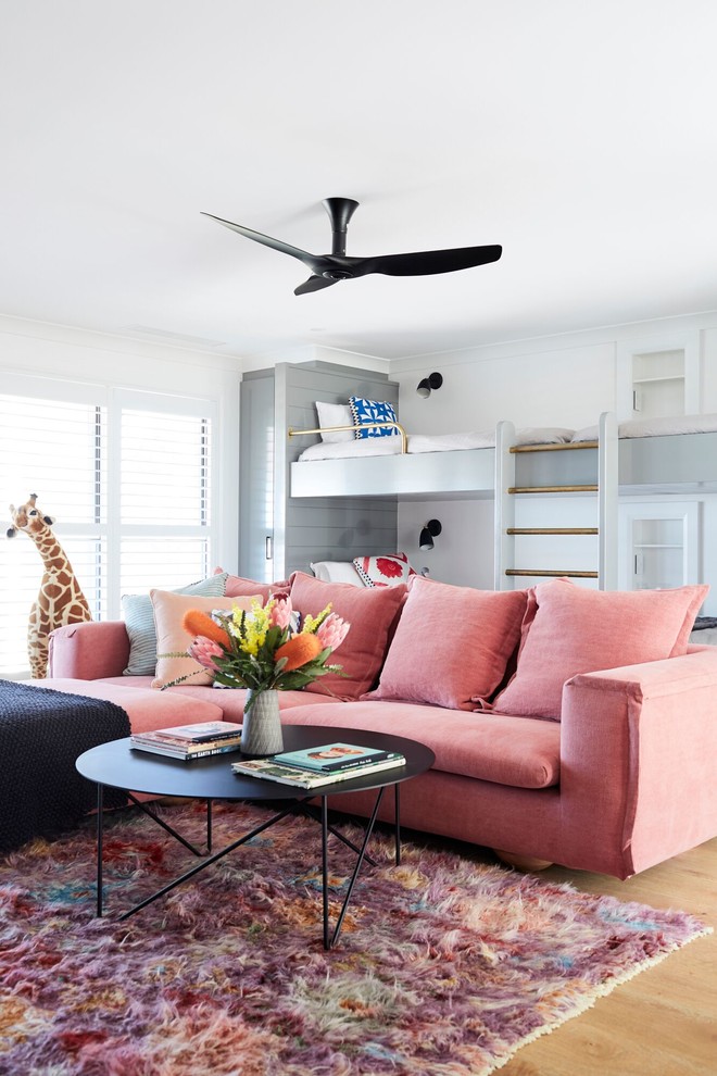 Design ideas for a kids' bedroom for teenage children and girls with white walls and light hardwood floors.