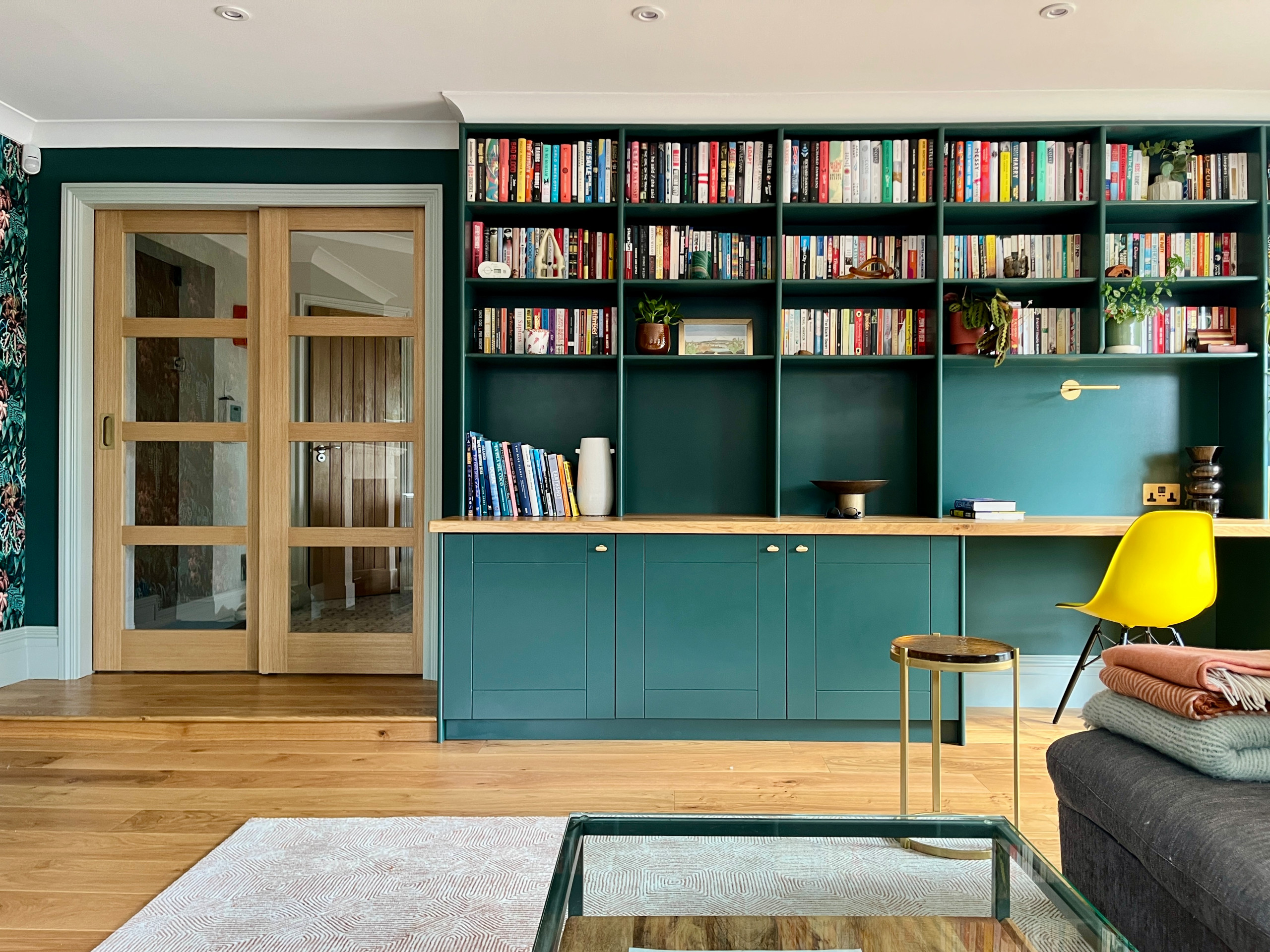 This project was a full redesign of a dated and heavily cluttered living room, transforming it into a vibrant, cohesive and multifunctional family space.