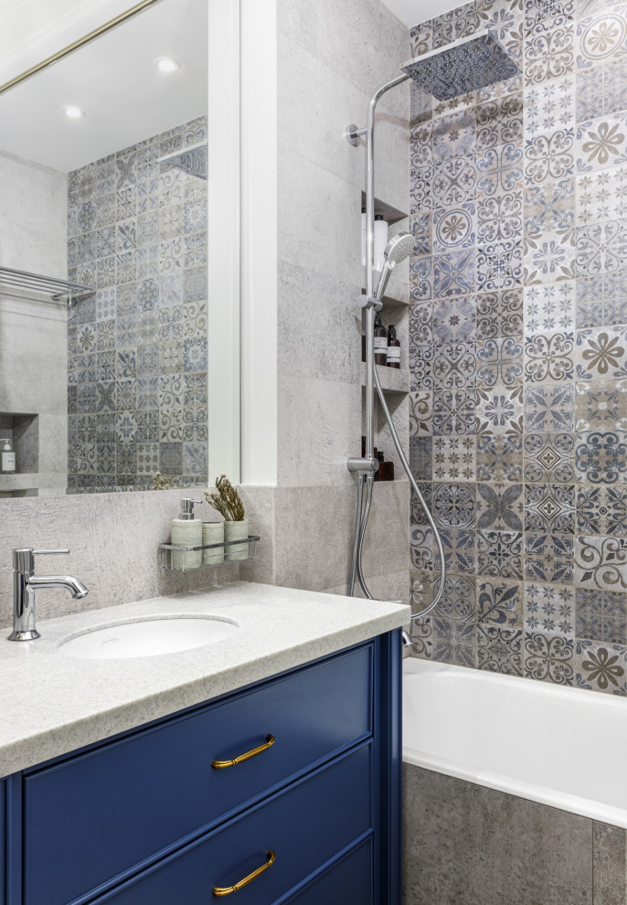 Example of a small classic master gray tile and ceramic tile ceramic tile, gray floor and single-sink alcove bathtub design in Moscow with raised-panel cabinets, blue cabinets, a wall-mount toilet, gray walls, an undermount sink, solid surface countertops, gray countertops and a freestanding vanity
