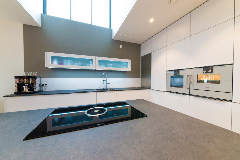 Design ideas for an expansive modern kitchen in Other with grey benchtop and white cabinets.