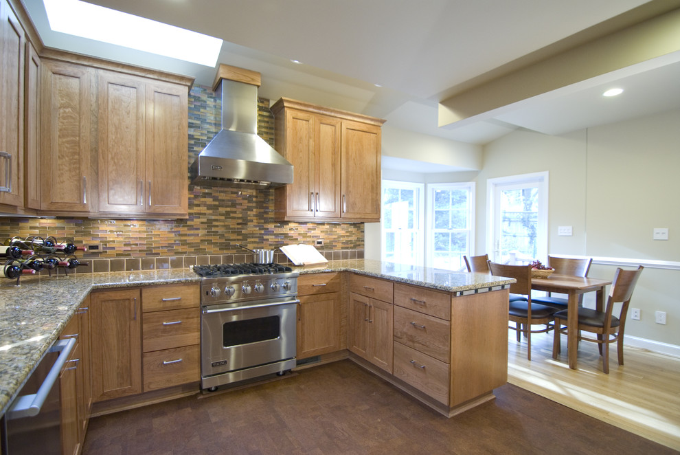 Traditional eat-in kitchen in DC Metro with shaker cabinets, medium wood cabinets and multi-coloured splashback.