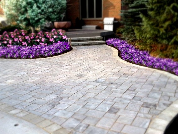 Design ideas for a mid-sized country backyard patio in Detroit with brick pavers.