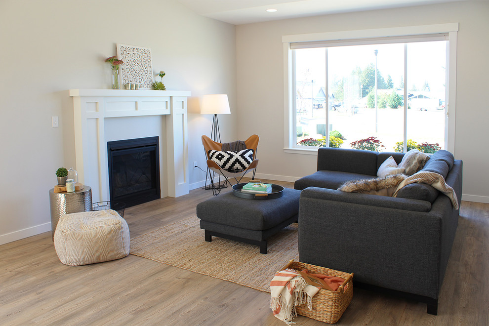 This is an example of a large arts and crafts open concept living room in Seattle with grey walls, vinyl floors, a standard fireplace, a tile fireplace surround and no tv.