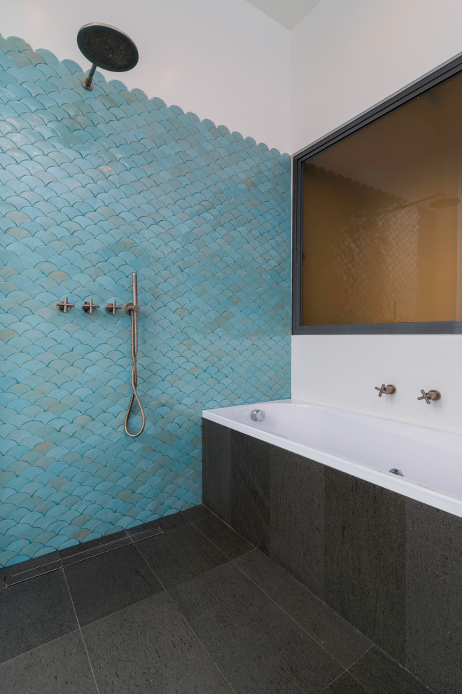 This is an example of a large modern 3/4 bathroom in Rome with open cabinets, grey cabinets, a drop-in tub, a curbless shower, blue tile, terra-cotta tile, white walls, ceramic floors, grey floor and an open shower.