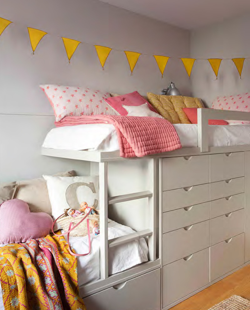 This is an example of a mid-sized transitional kids' bedroom for kids 4-10 years old and girls in Madrid with white walls and medium hardwood floors.