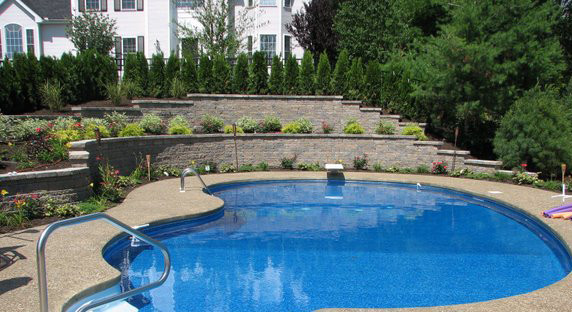 Example of a large backyard stone and custom-shaped pool design in Boston