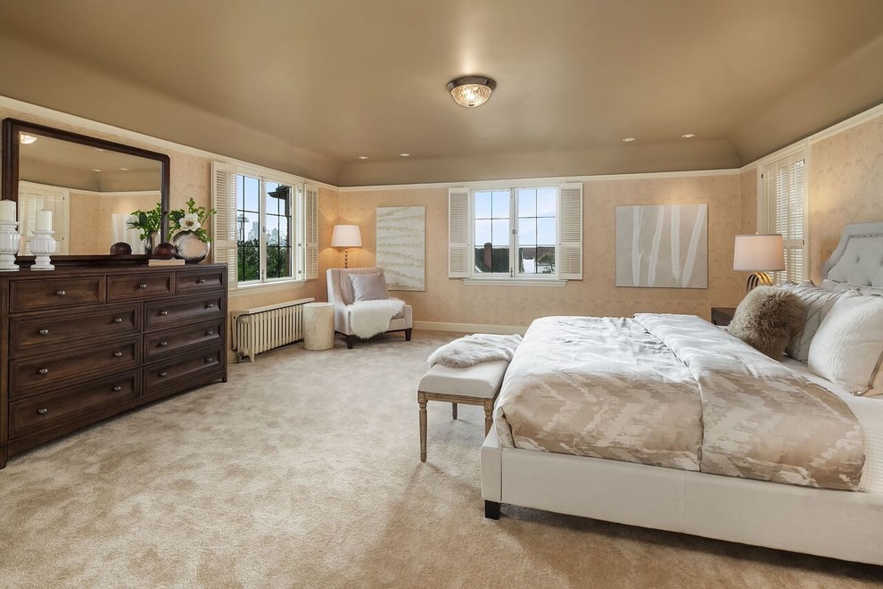 Inspiration for a large classic master bedroom in Seattle with beige walls, carpet and beige floors.