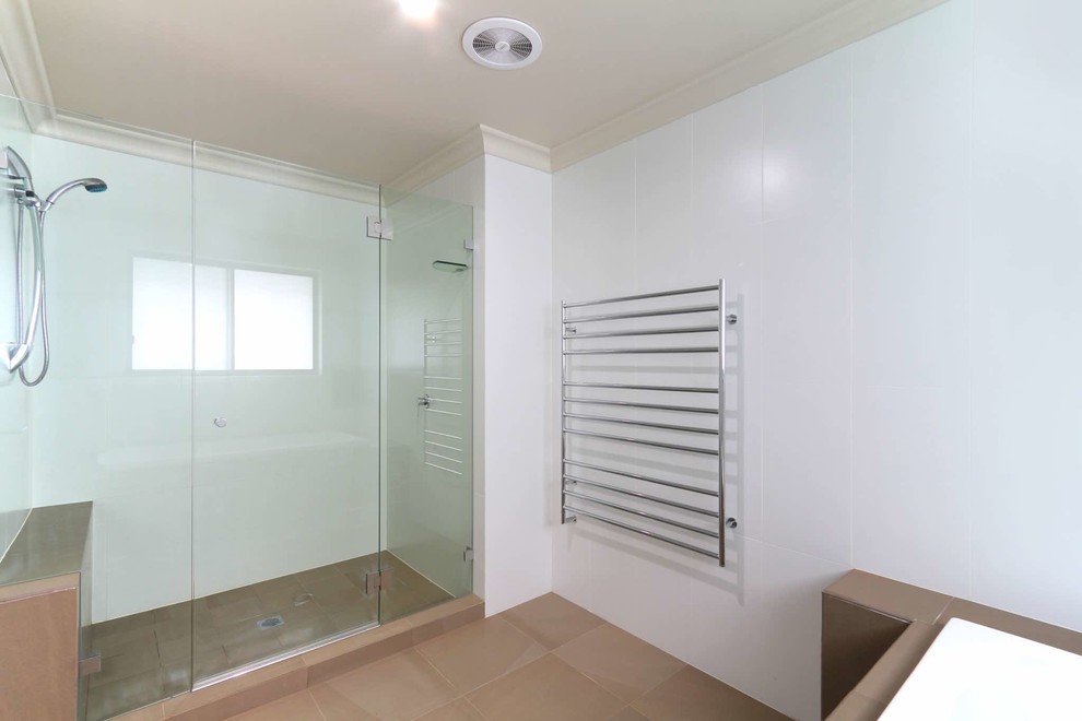This is an example of a large contemporary 3/4 bathroom in Sydney with a double shower, multi-coloured tile, porcelain tile, white walls and porcelain floors.