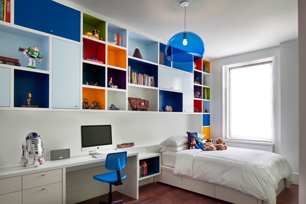 Photo of a contemporary kids' bedroom for kids 4-10 years old and boys in New York with medium hardwood floors and white walls.