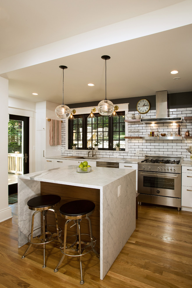 Design ideas for a mid-sized transitional kitchen in DC Metro with an undermount sink, flat-panel cabinets, white cabinets, granite benchtops, white splashback, stainless steel appliances, with island, medium hardwood floors and subway tile splashback.