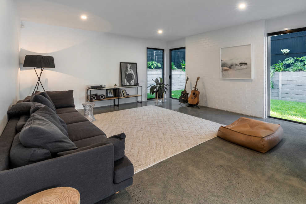 Contemporary living room with white walls and concrete floors.
