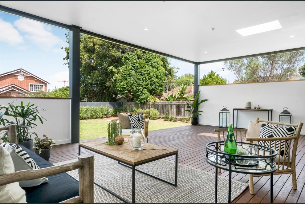 Inspiration for a mid-sized contemporary backyard patio in Sydney with decking and a roof extension.