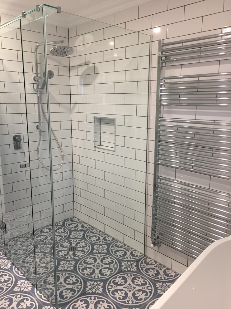Mid-sized contemporary master bathroom in Melbourne with white cabinets, a freestanding tub, white tile, subway tile, white walls, mosaic tile floors, blue floor, a hinged shower door, white benchtops, a double vanity and a built-in vanity.