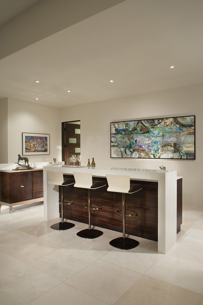 Photo of a mid-sized contemporary single-wall seated home bar in Phoenix with flat-panel cabinets, dark wood cabinets, quartz benchtops, white splashback, marble floors, white floor and white benchtop.