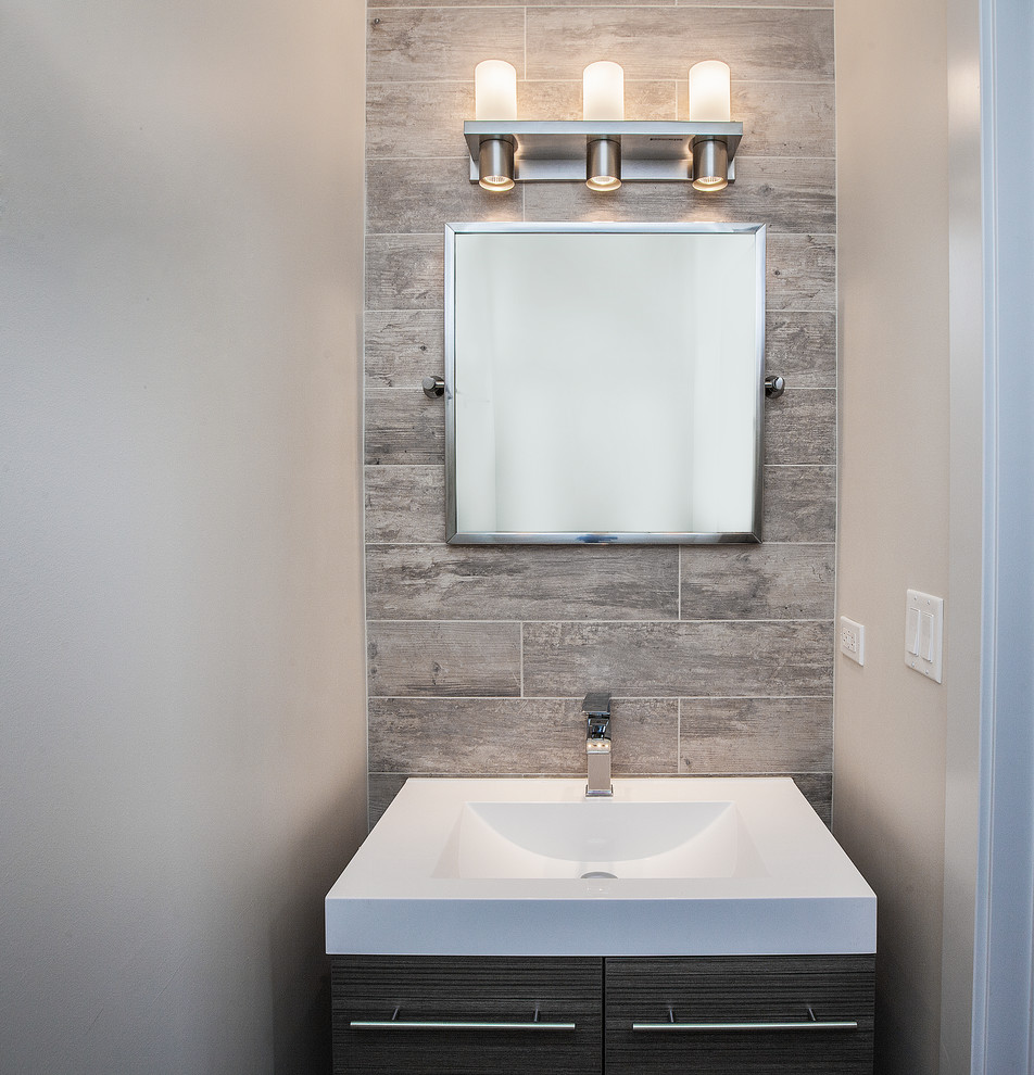 Inspiration for a mid-sized modern 3/4 bathroom in Chicago with glass-front cabinets, tile benchtops and beige tile.