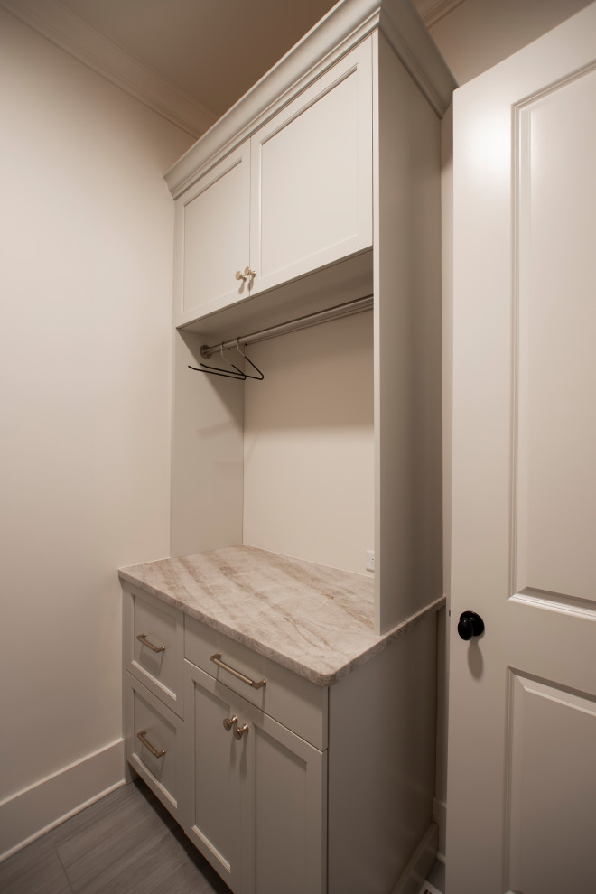 Example of a large transitional l-shaped dark wood floor and brown floor open concept kitchen design in Nashville with an undermount sink, beaded inset cabinets, white cabinets, quartzite countertops, beige backsplash, stone slab backsplash, stainless steel appliances, an island and beige countertops