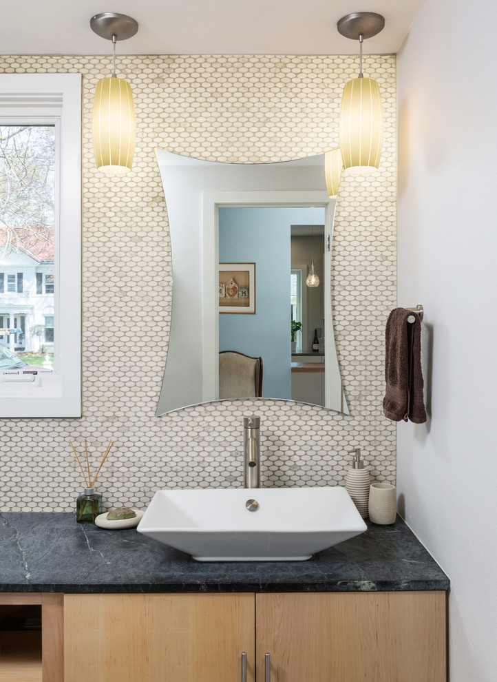 Design ideas for a mid-sized contemporary powder room in Milwaukee with flat-panel cabinets, light wood cabinets, a two-piece toilet, white tile, mosaic tile, beige walls, porcelain floors, a vessel sink and soapstone benchtops.