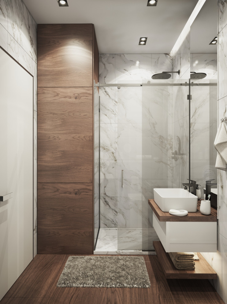 This is an example of a small modern master bathroom in San Francisco with glass-front cabinets, a corner shower, a wall-mount toilet, marble, grey walls, painted wood floors, a sliding shower screen, a single vanity, coffered and panelled walls.