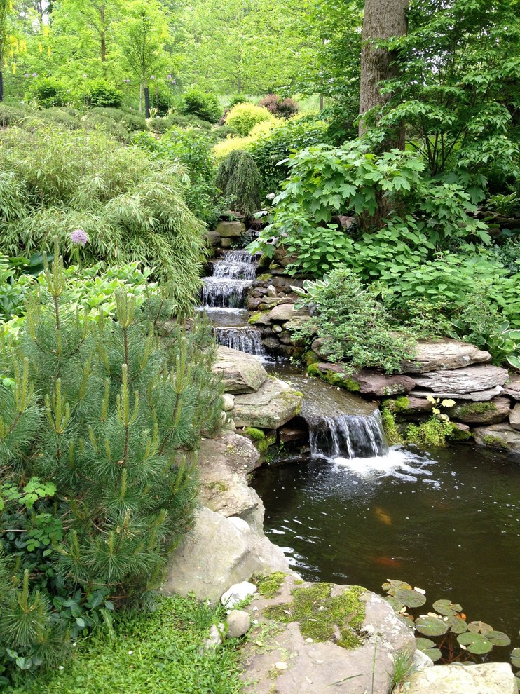 Photo of a country partial sun garden in New York with with waterfall.