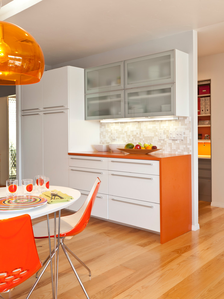 Midcentury kitchen in Other with orange benchtop.