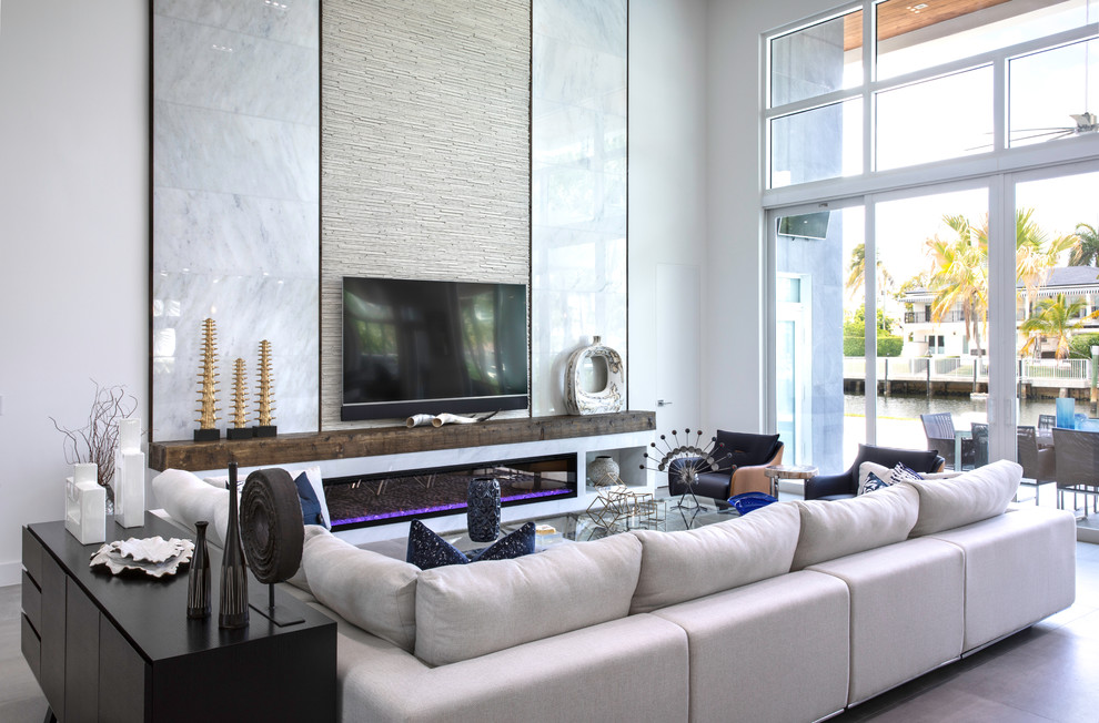 Design ideas for a contemporary formal open concept living room in Miami with white walls, a ribbon fireplace, a wall-mounted tv and brown floor.